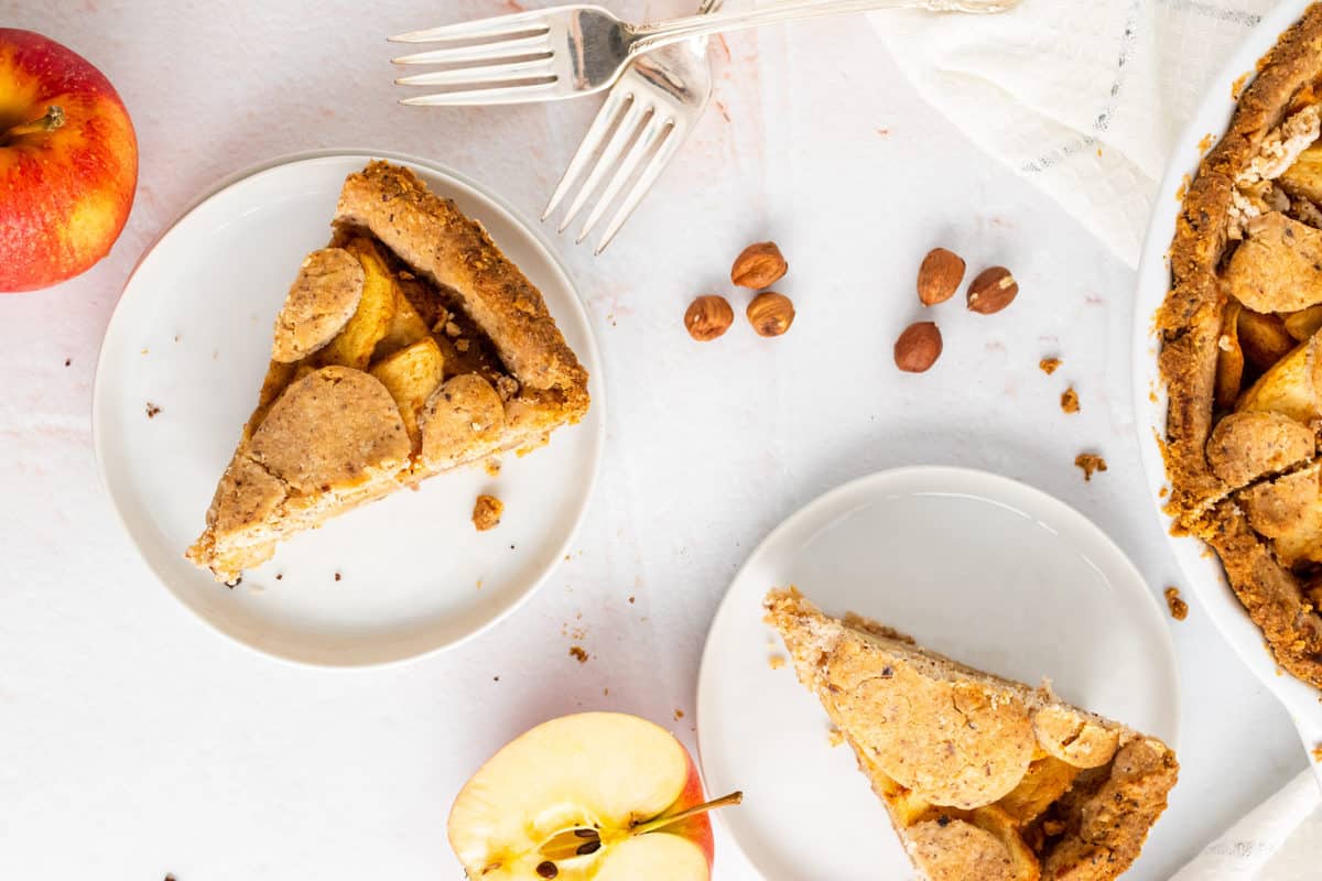 paleo apple pie slices served on white plates 