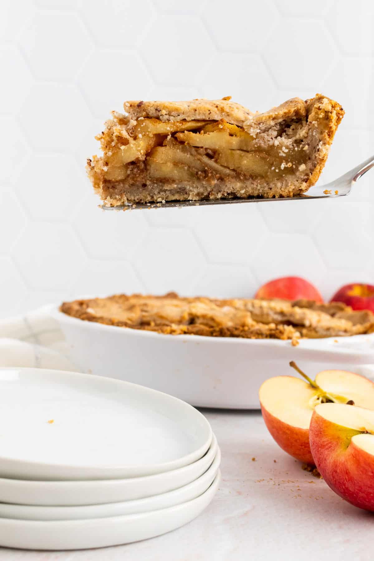 paleo apple pie cut and being lifted and served