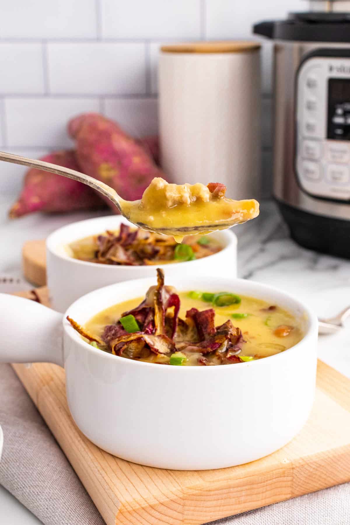 two. bowls of whole30 turkey chili with a spoonful being picked up