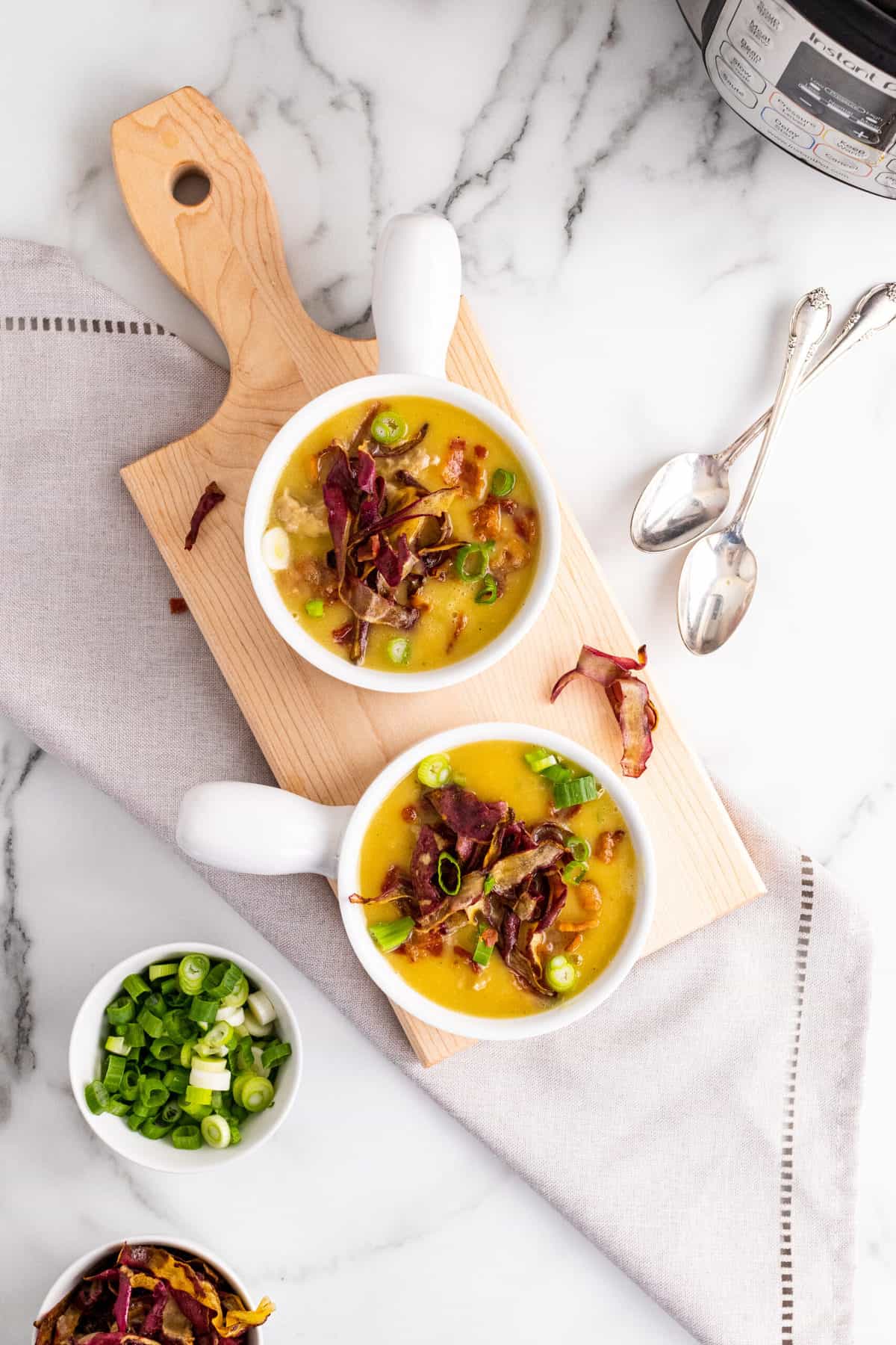 two while bowls on a cutting board with sweet potato turkey chili