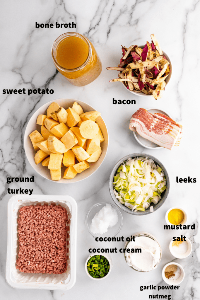 ingredients for sweet potato turkey chili all measured out in bowls over a marble back drop