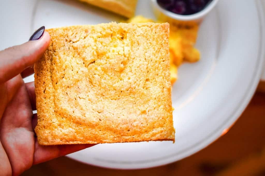 woman's hand holding a slice of bread