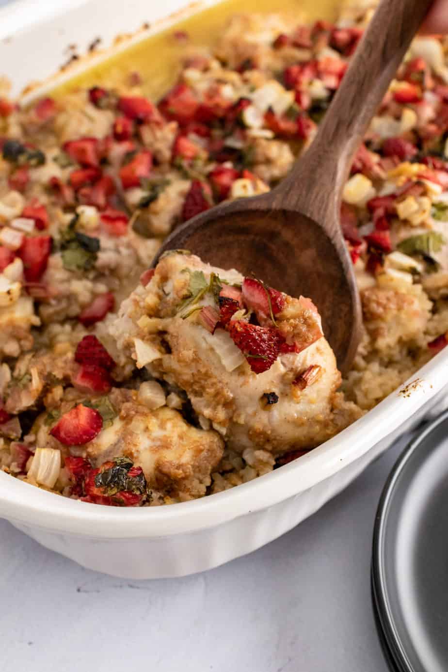 strawberry salsa chicken  bake in pie pan with a wooden spoon 