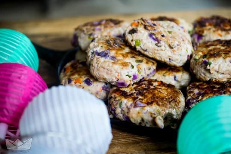 confetti turkey burgers in a skillet surrounded by colorful lanterns