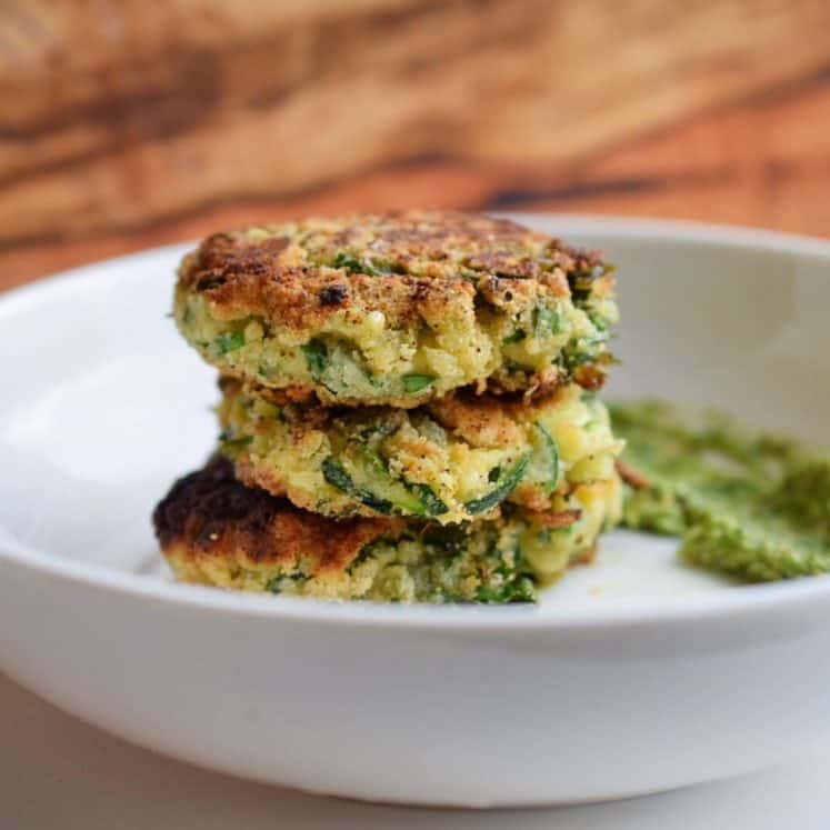 zucchini fritters stacked in white bowl