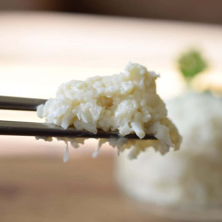 chopsticks holding paleo sushi rice
