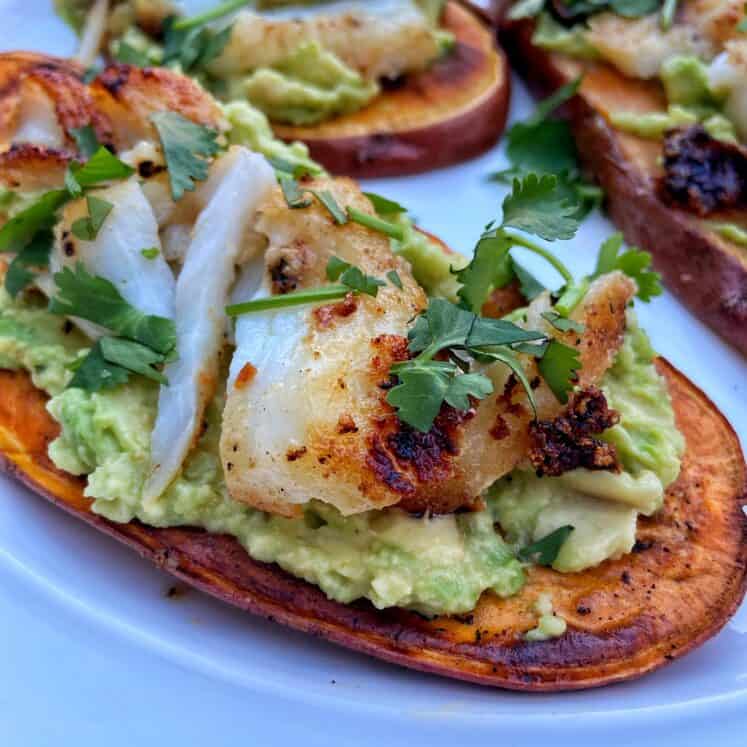 sliced sweet potato loaded with avocado, grilled fish and cilantro