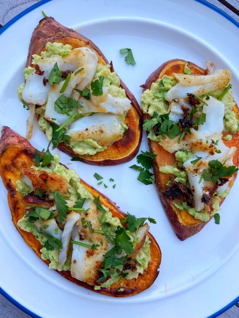 sliced sweet potato loaded with avocado, grilled fish and cilantro