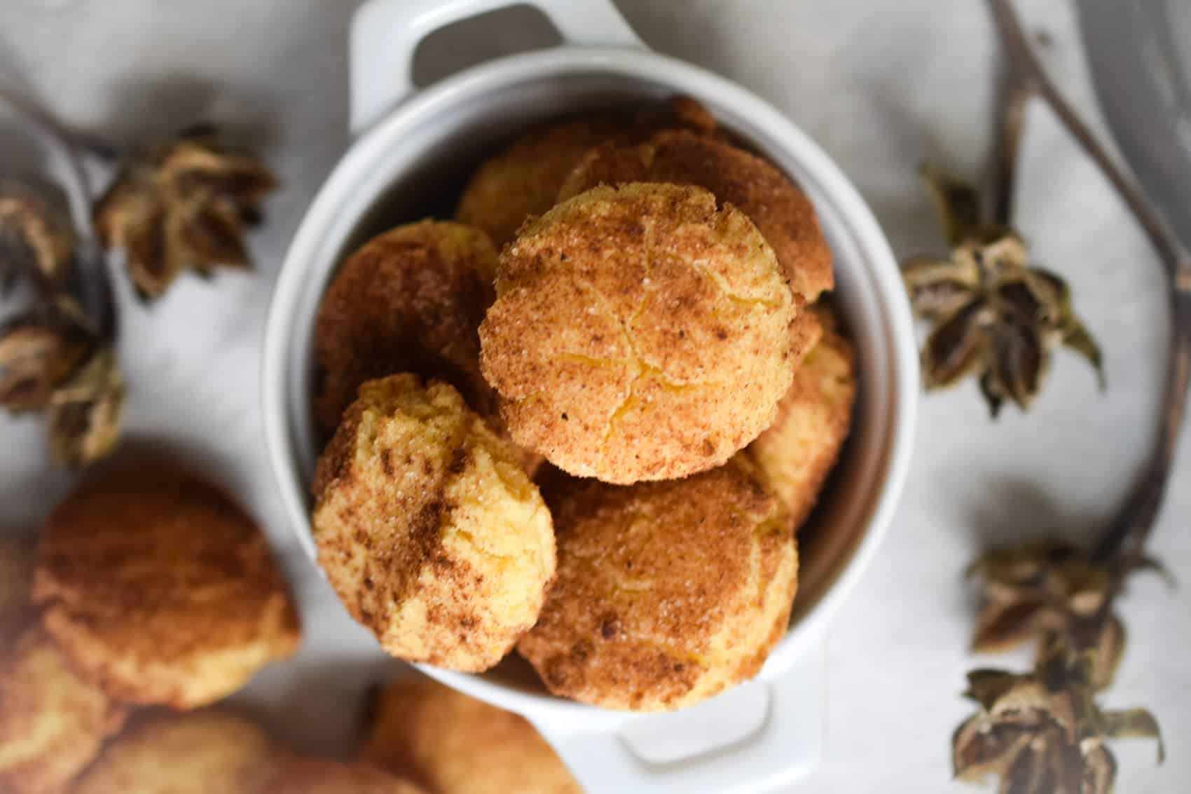 a bunch of nut free keto snickerdoodle cookies in a small white ramekin photographed from above