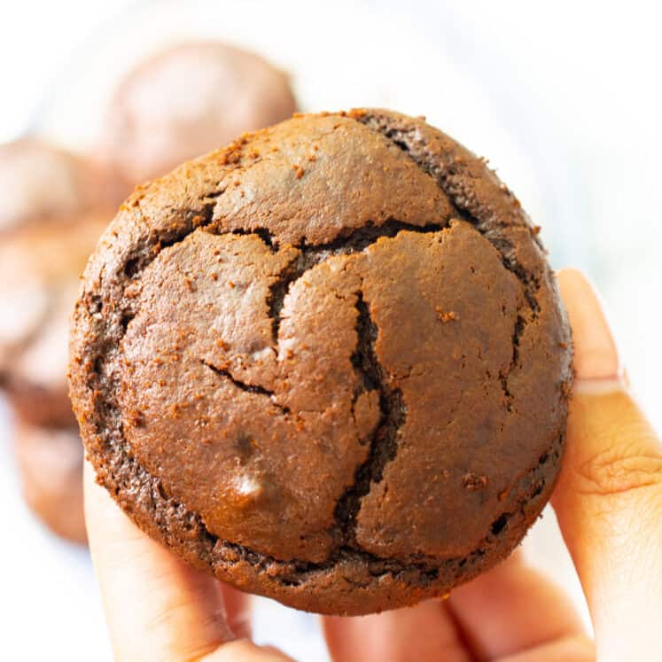 hand holding a flourless chocolate muffin