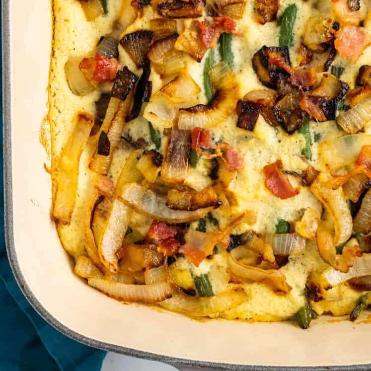 close up of a whole30 green bean casserole in a ceramic dish