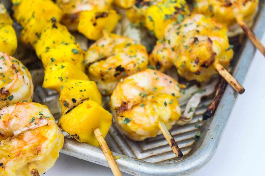 Succulent skewered shrimp, marinated in a garlic mango sauce, grilled to perfection alongside in-season mango cubes, all served kebab style.