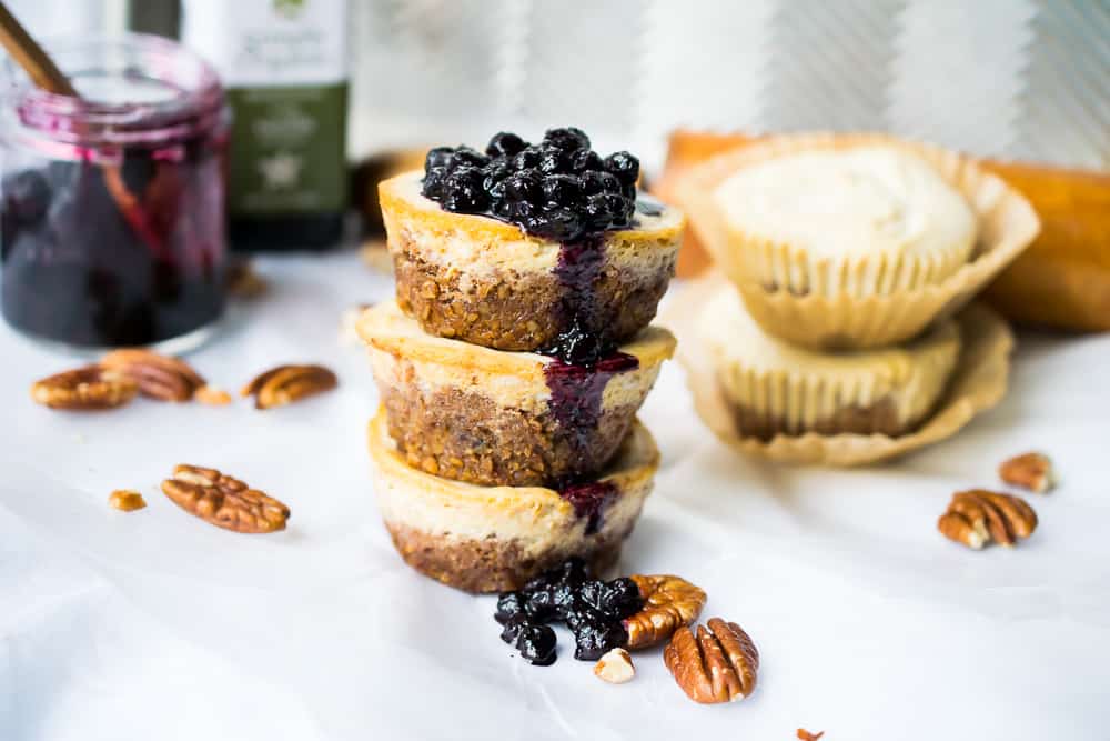 3 vegan cheesecake bites keto stacked with blueberry sauce