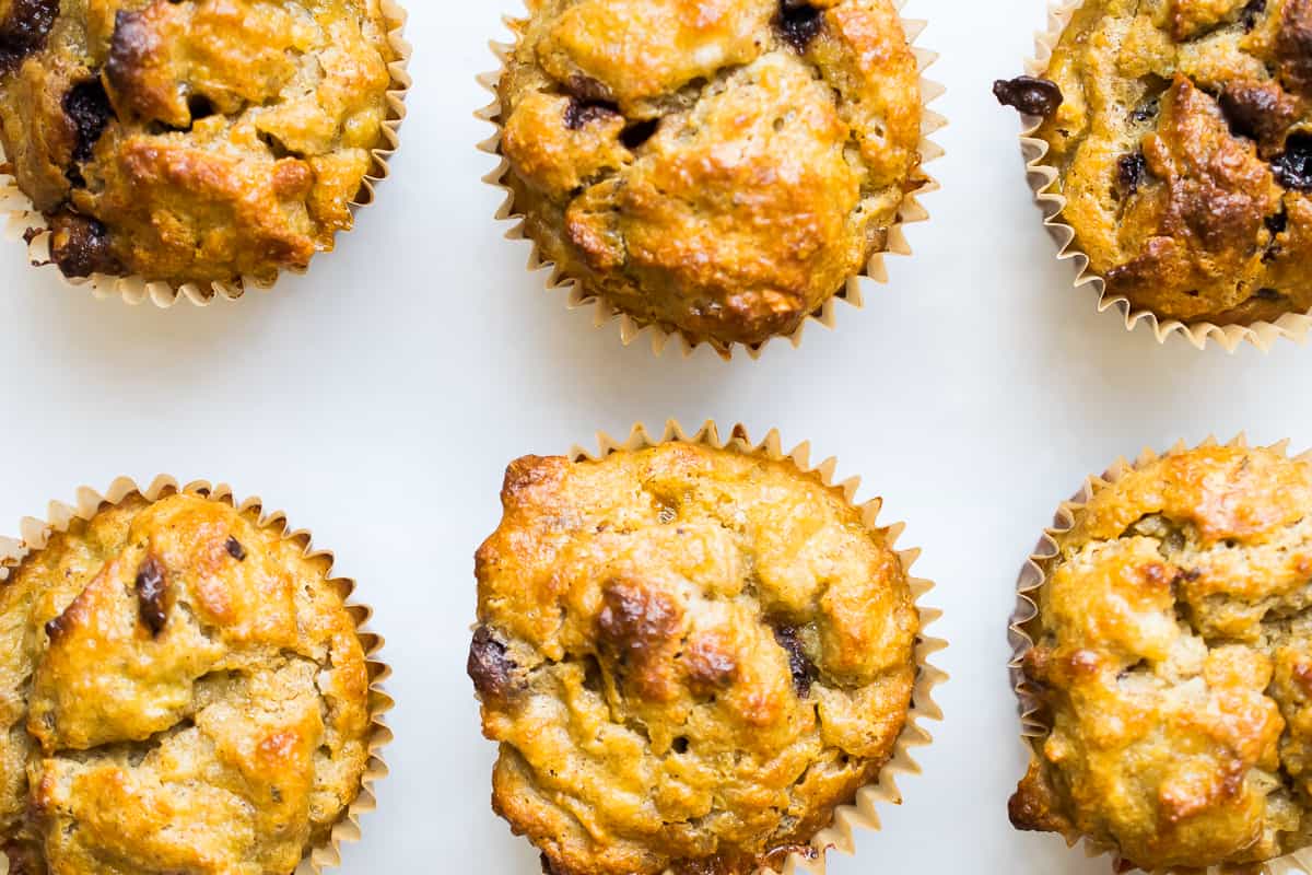 banana nut muffins on a white counter lined up 