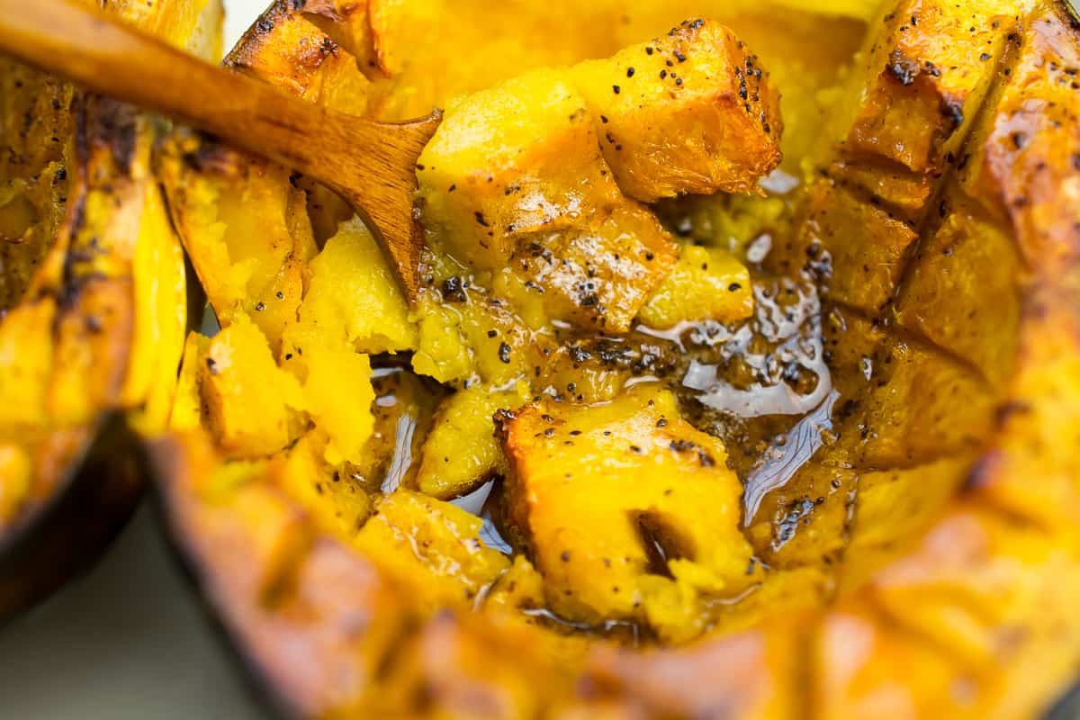 roasted acorn squash close up seasoned with butter 