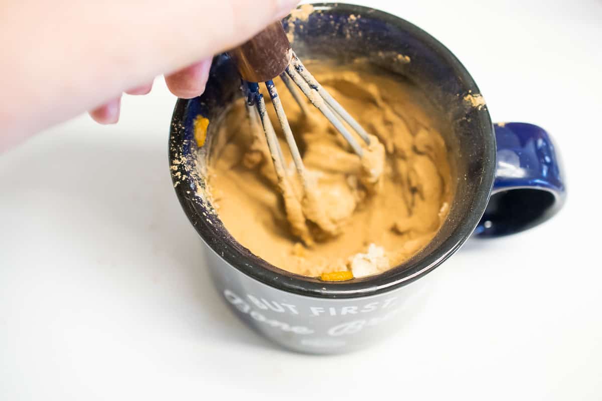 aip brownie mug cake ingredients being mixed, now a light brown