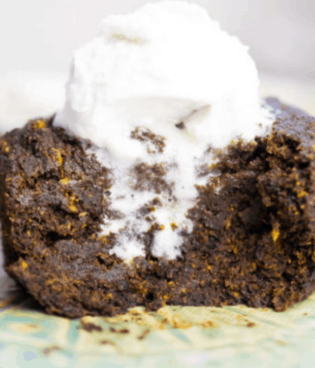 AIP Brownie Mug Cake cut in half, topped with coconut cream.