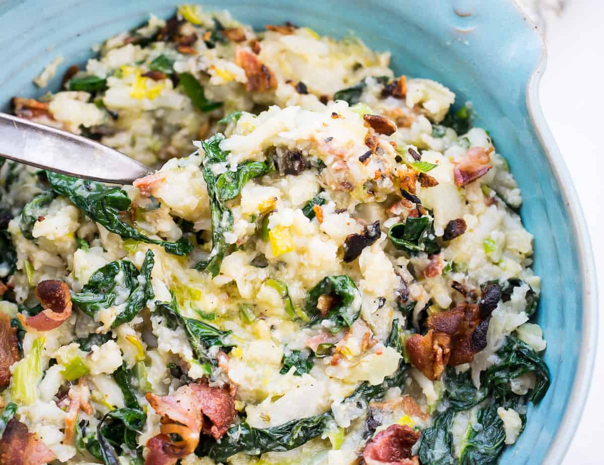 aip cauliflower colcannon in blue platter with a spoon in it 