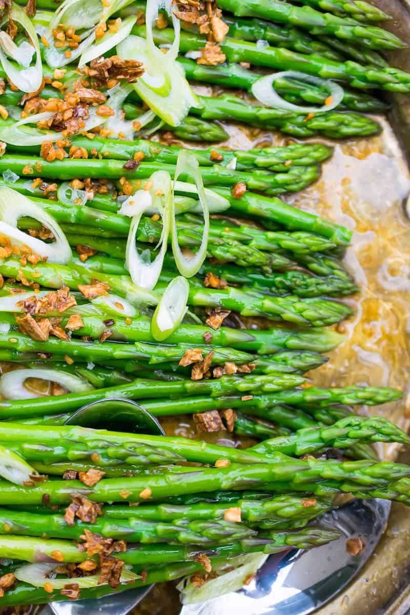 juicy AIP ASPARAGUS SALAD on dish, garnished with fried garlic and green onion