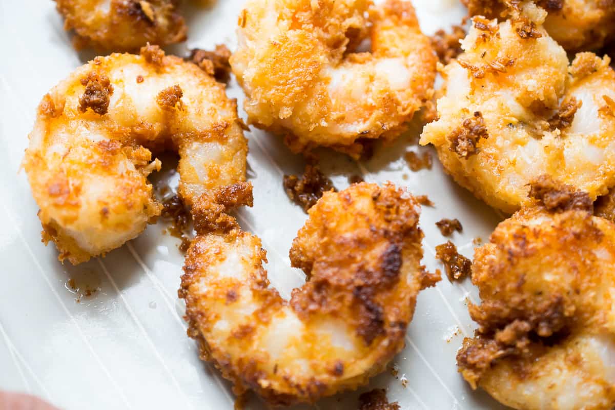 6 toasty fried coconut shrimps on a pan 