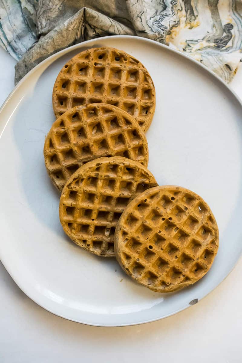four nut free paleo waffles stacked over each other on a plate