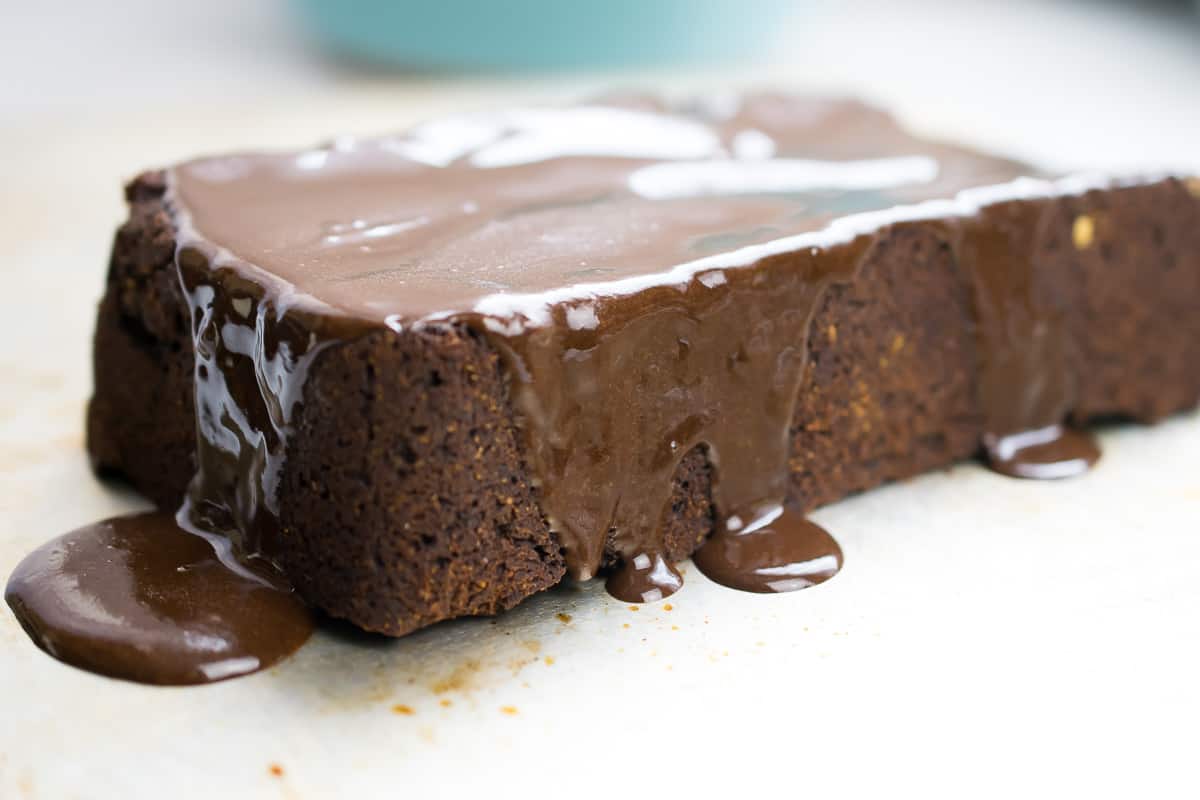one long strip of aip brownie with glaze dripped on top and off sides