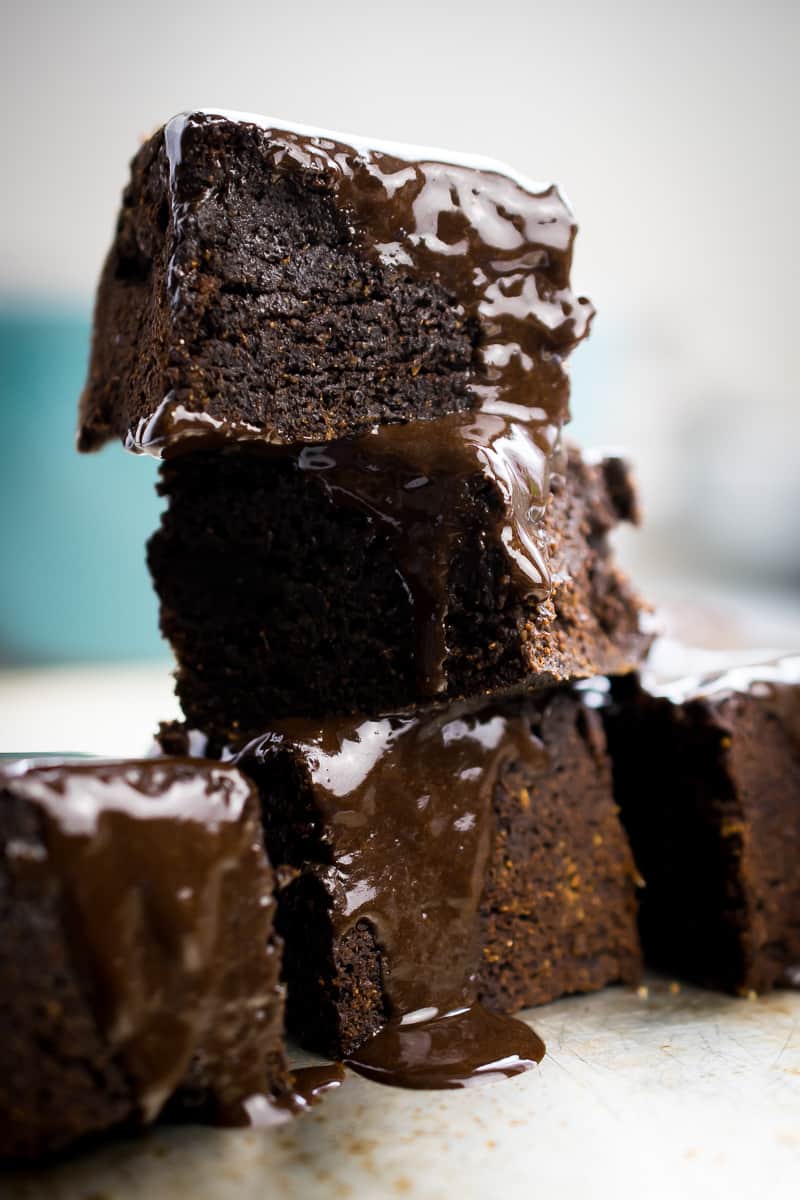 aip glazed brownies stacked on each other with glaze poured over