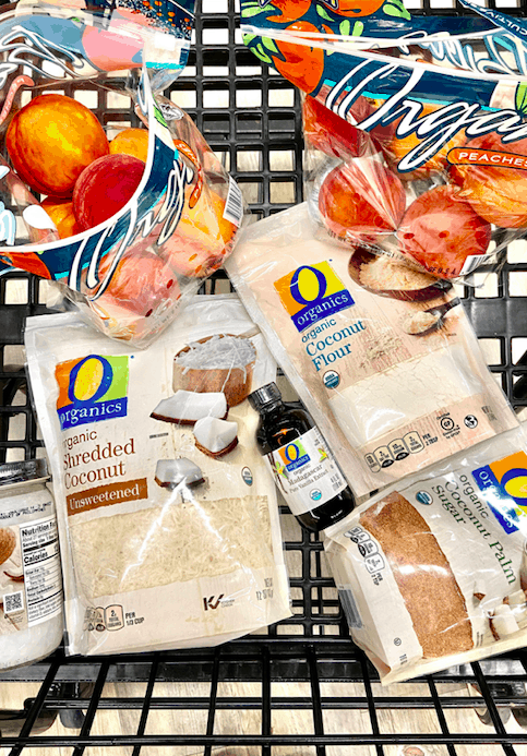 shopping cart with O organics products in it: shredded coconut, vanilla extract, coconut flour, coconut palm sugar and organic peaches 