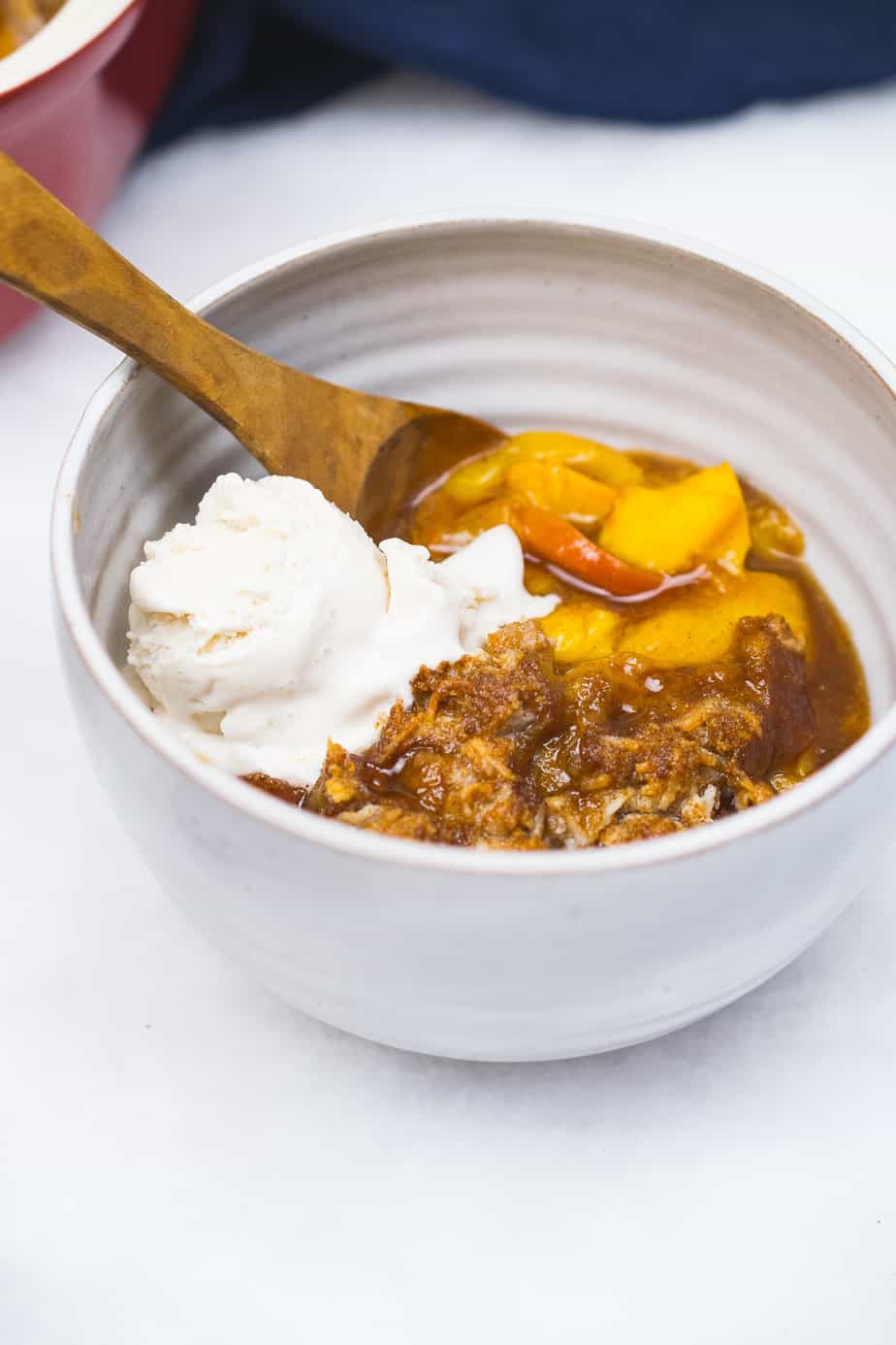 aip peach cobbler served in mug with coconut cream 