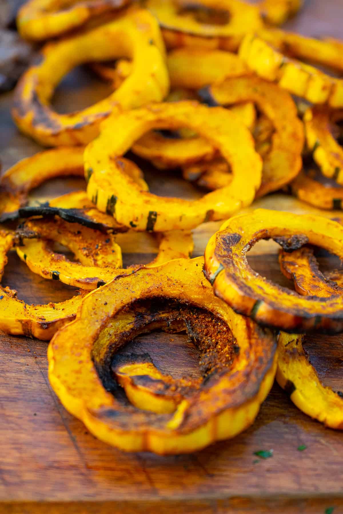 delicata squash chips on a wooden cutting board