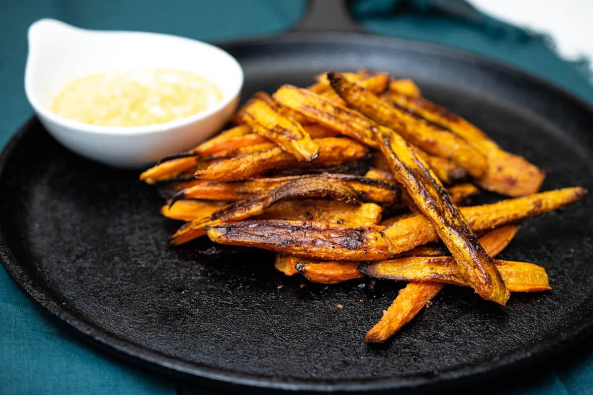 crispy roasted carrot fries on a cast iron skillet