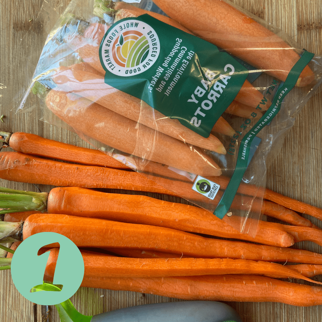 peeled carrots and baby carrots on a cutting board