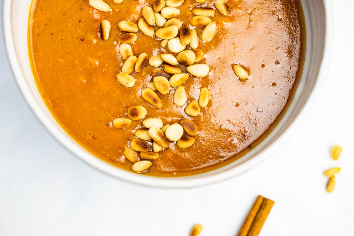 sweet potato protein porridge in a ceramic bowl with toasted pine nuts 