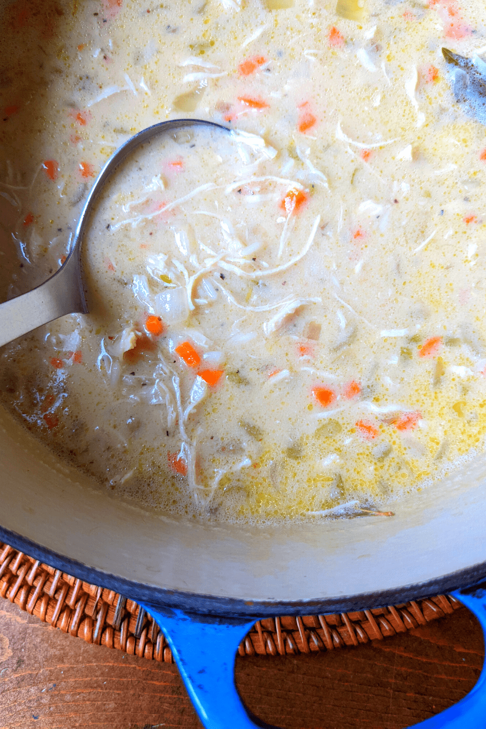 greek chicken soup in a pot with a ladle