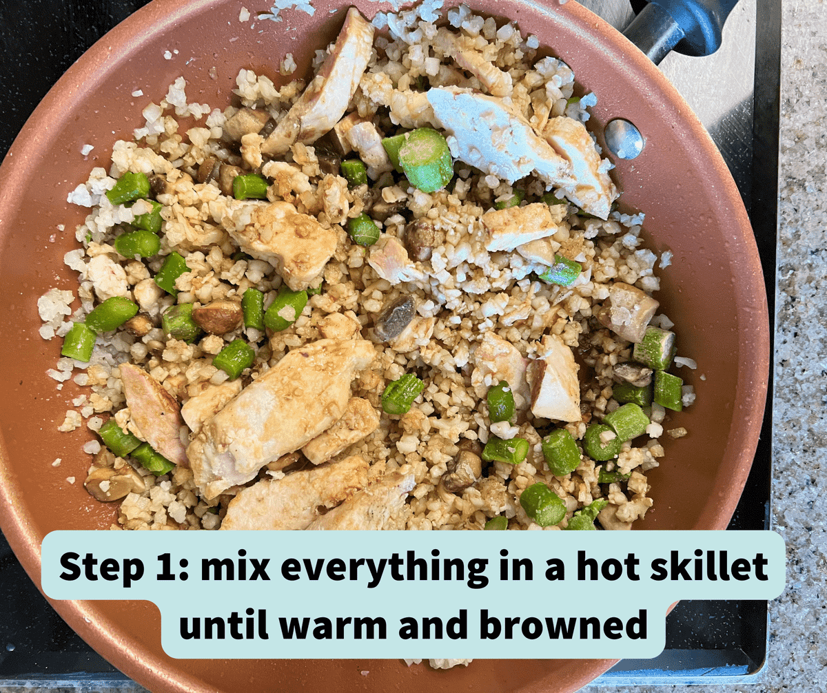 ceramic skillet with a mix of riced cauliflower, asparagus, mushrooms and chicken breast