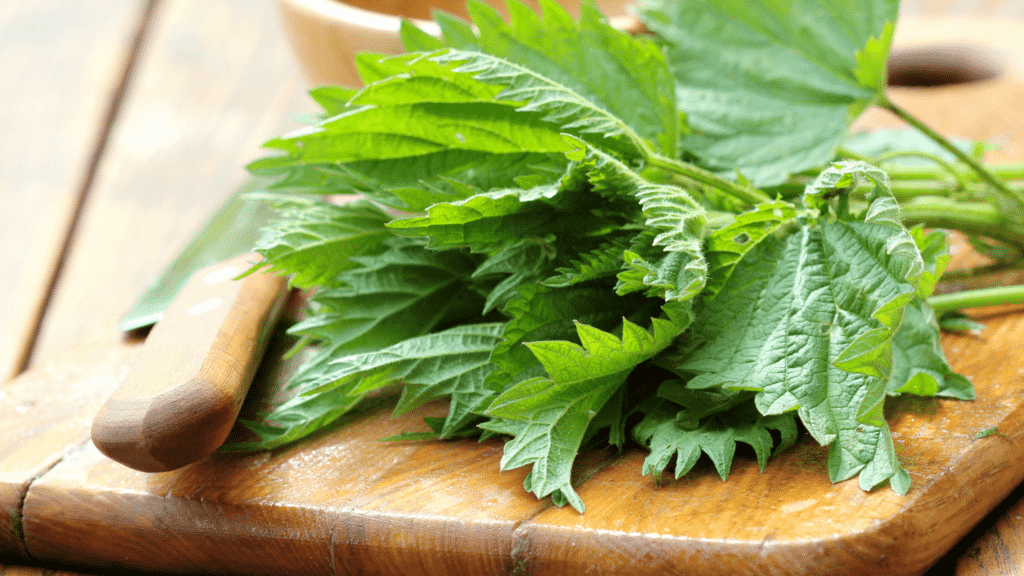 stringing nettle on a wooden cutting board