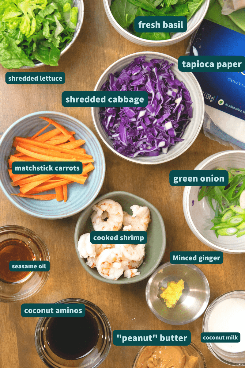 measured and labeled ingredients for paleo spring rolls on a wooden counter