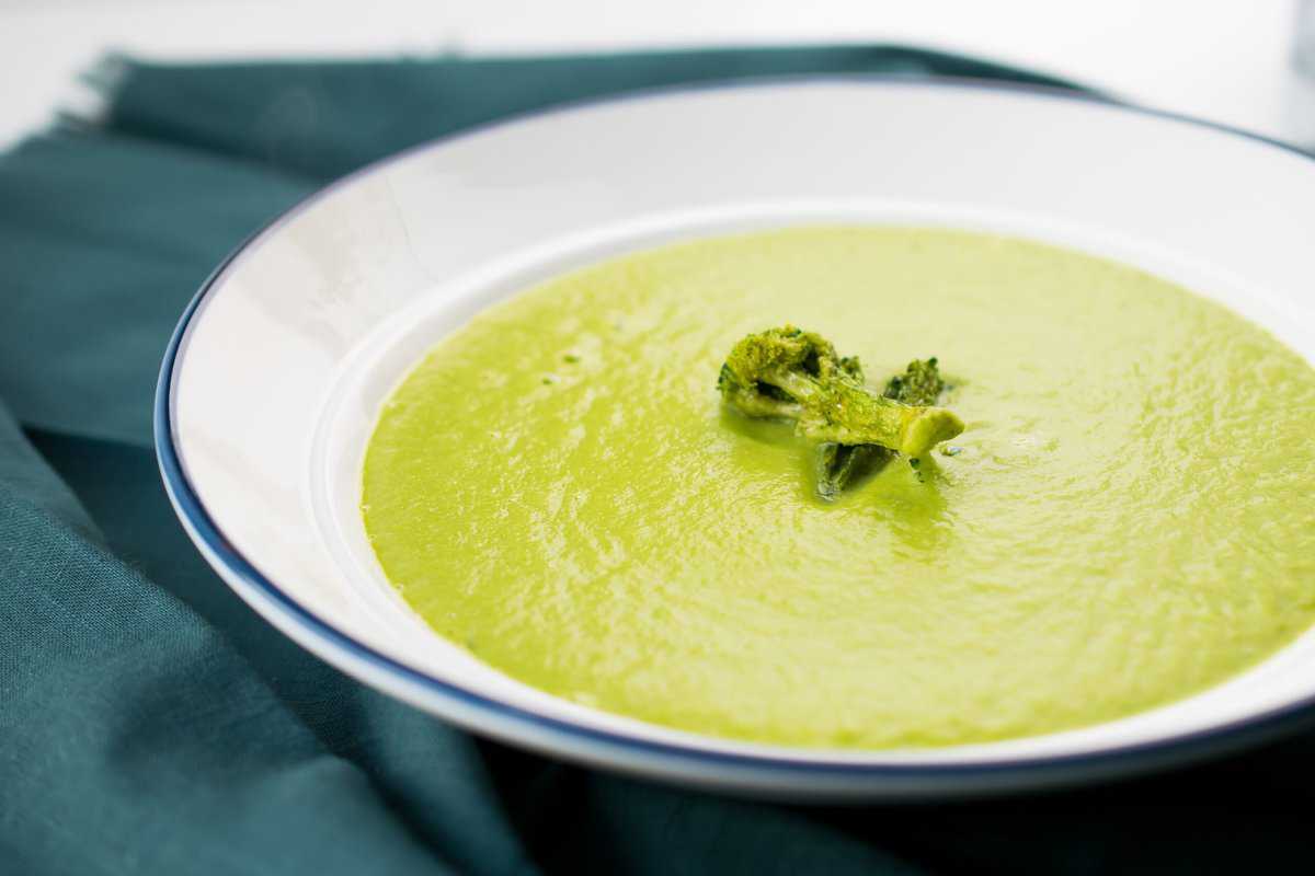 bowl of aip asparagus soup on a blue napkin 