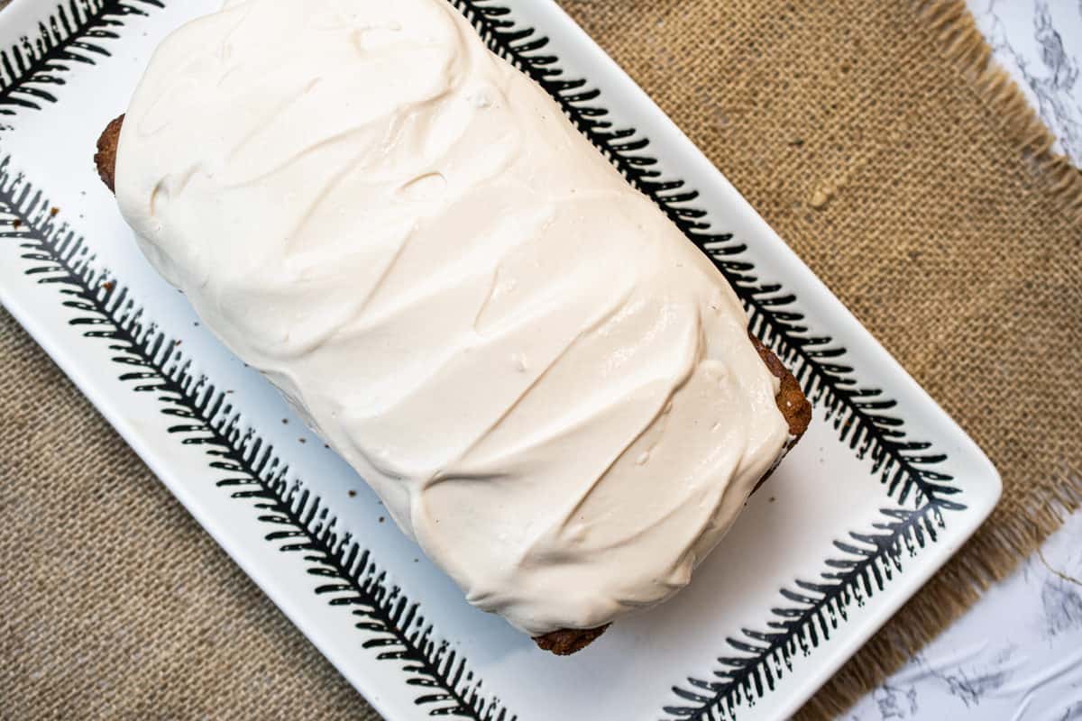 from the top a paleo carrot cake with smooth dairy free cream cheese frosting 