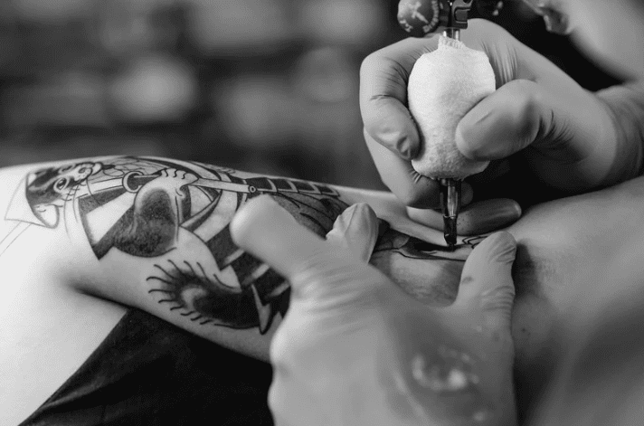 black and white image of person getting tattooed immune system