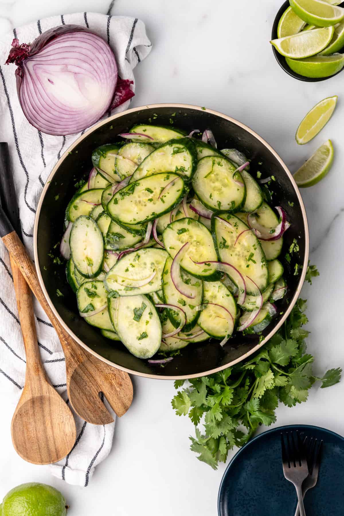 summer cucumber salad with lime and cilantro around bowl