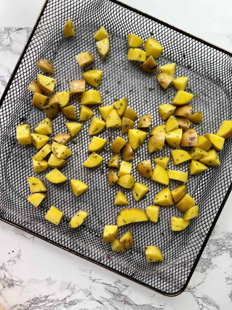 diced potatoes in air fryer basket