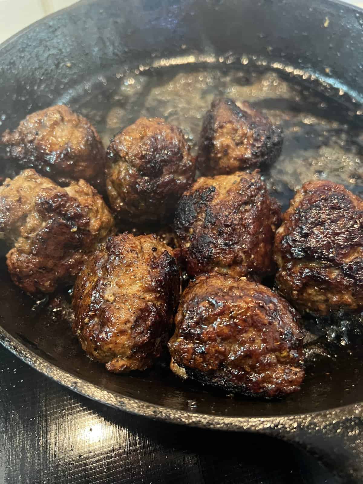 lamb meatballs with balsamic in cast iron skillet